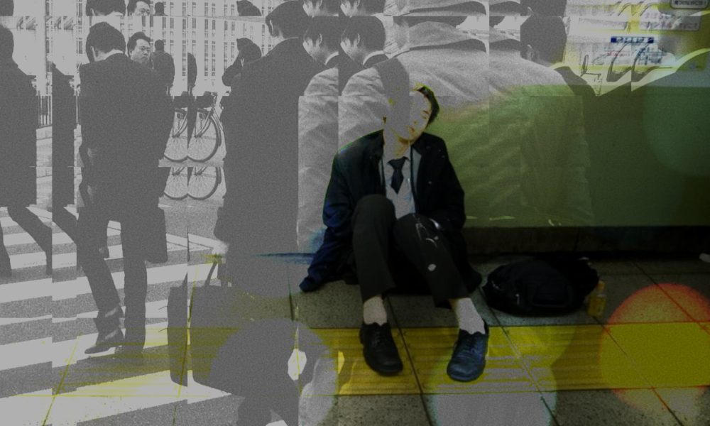 Exhausted Salaryman sleeps on a train platform